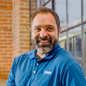 Smiling man in a Fidelity branded shirt